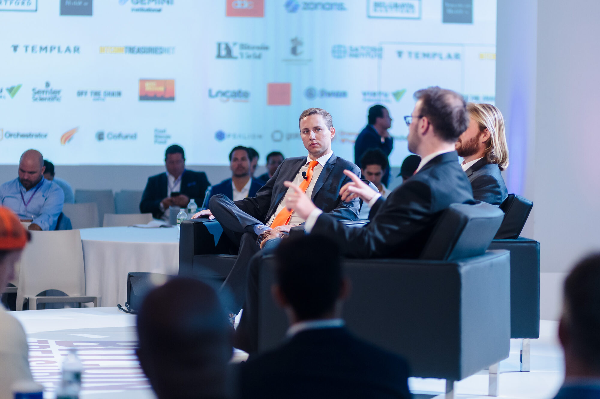 Business leaders in conversation during a conference panel