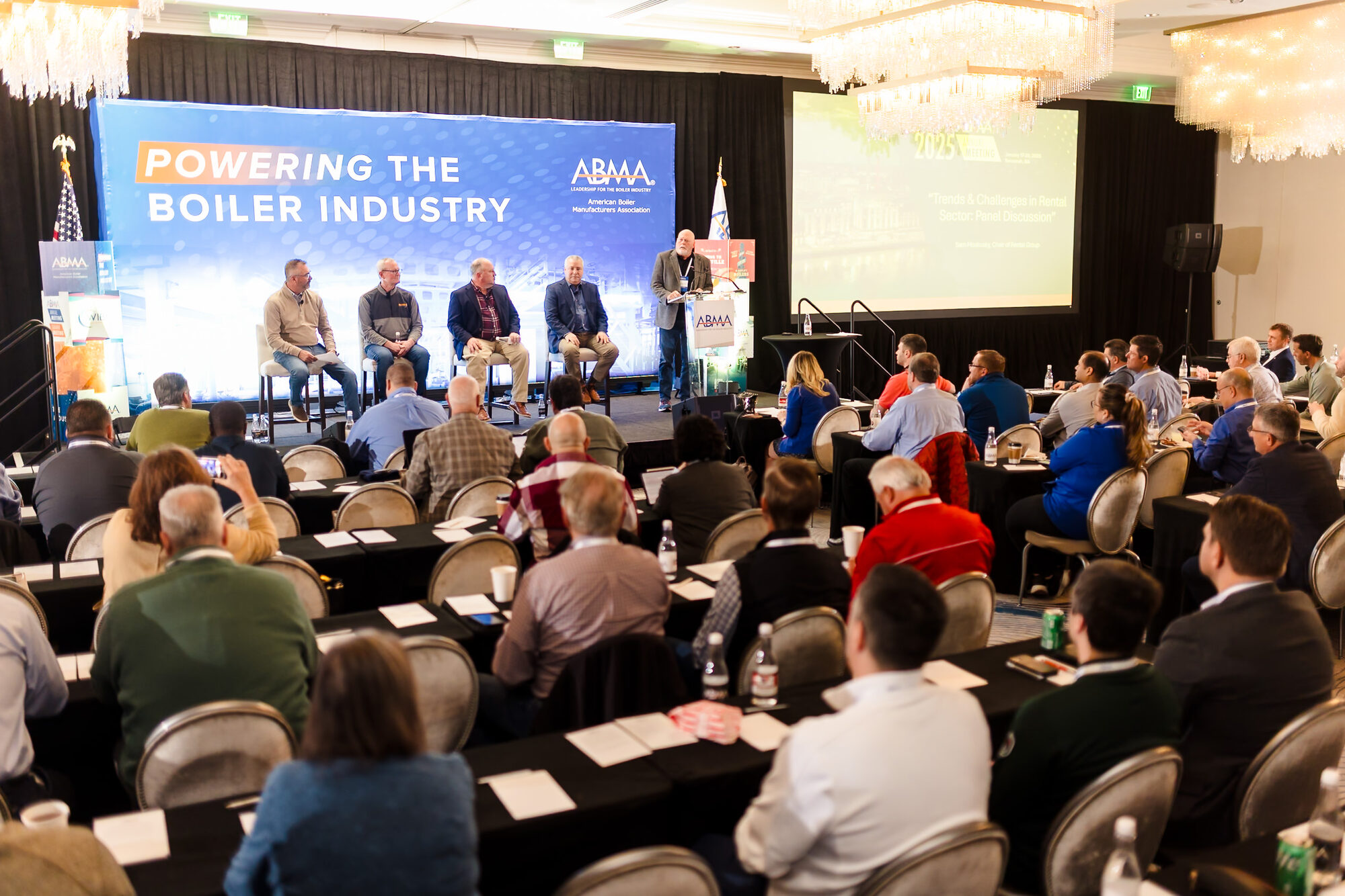 Audience watching a panel discussion at a corporate conference
