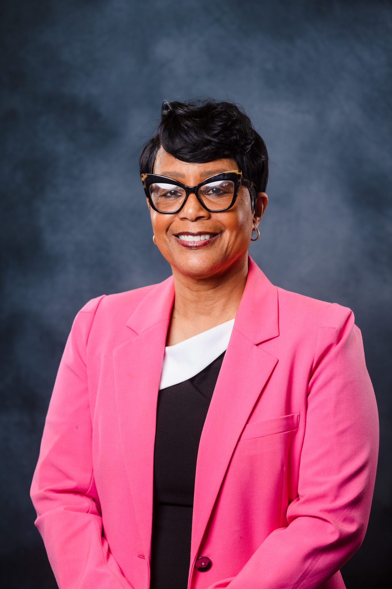 Professional portrait of a woman in a pink blazer