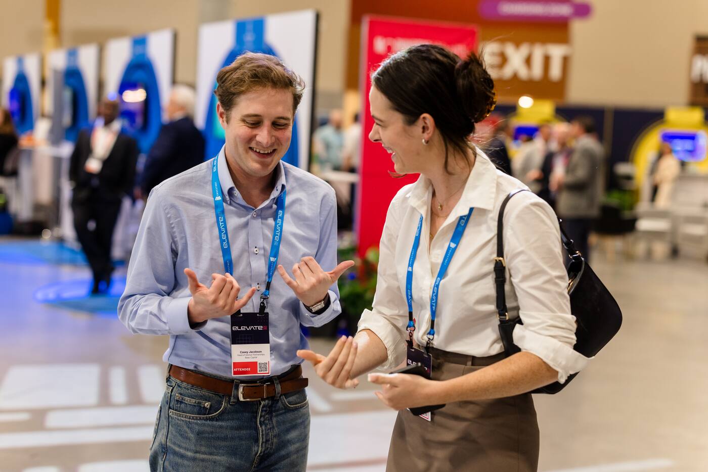 Two attendees in conversation on the expo floor