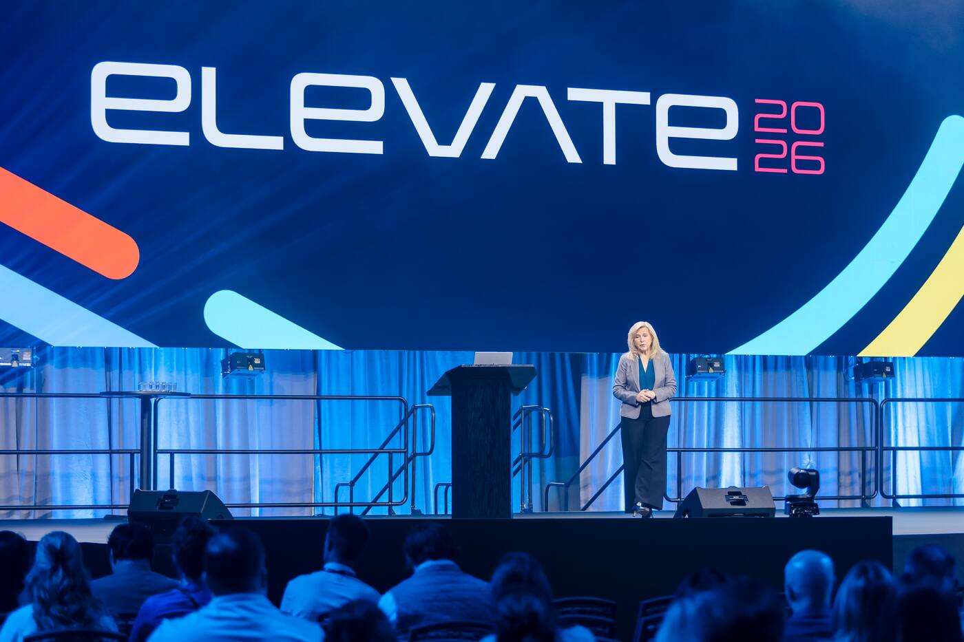 Wide view of a general session speaker and audience